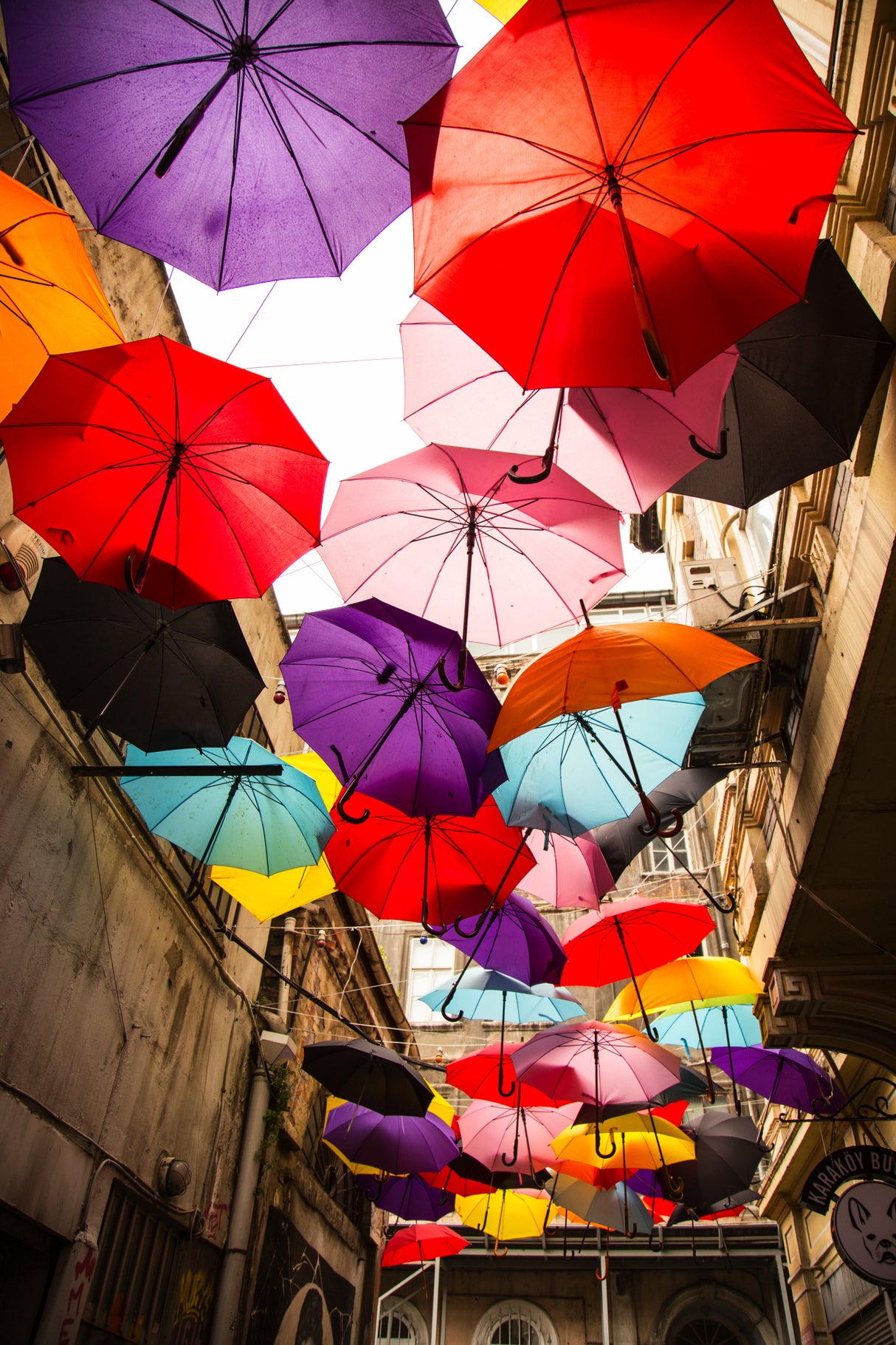 old building and decorative umbrellas Poster och Canvastavla