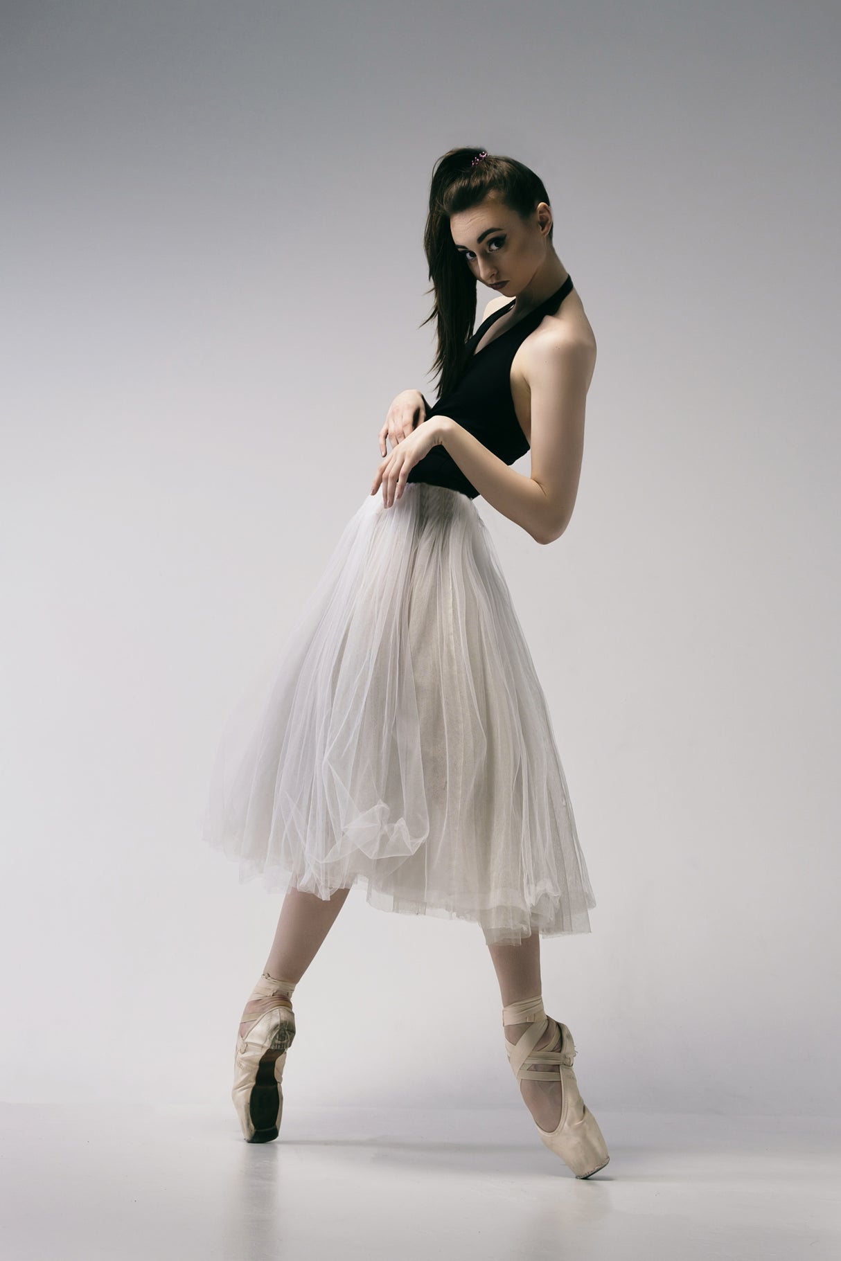 The coquetry. a young ballerina in a black skirt and Chopin is standing on pointe shoes Poster och Canvastavla