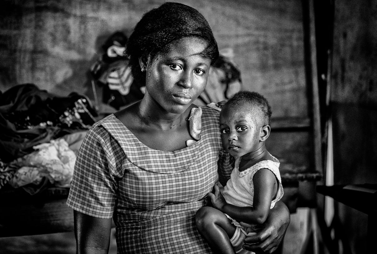 Mother and her child in a sewing company in Ghana. Poster och Canvastavla