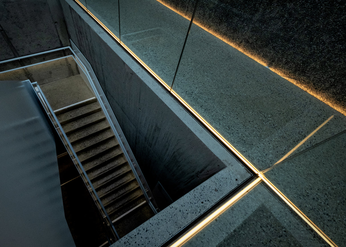 warm light in a cold staircase Poster och Canvastavla