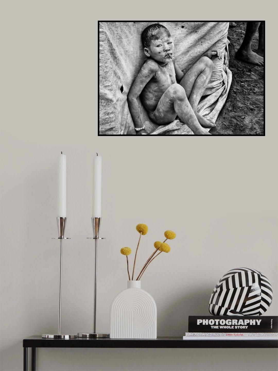 Mundari child playing with a bullet casing - South Sudan Poster och Canvastavla