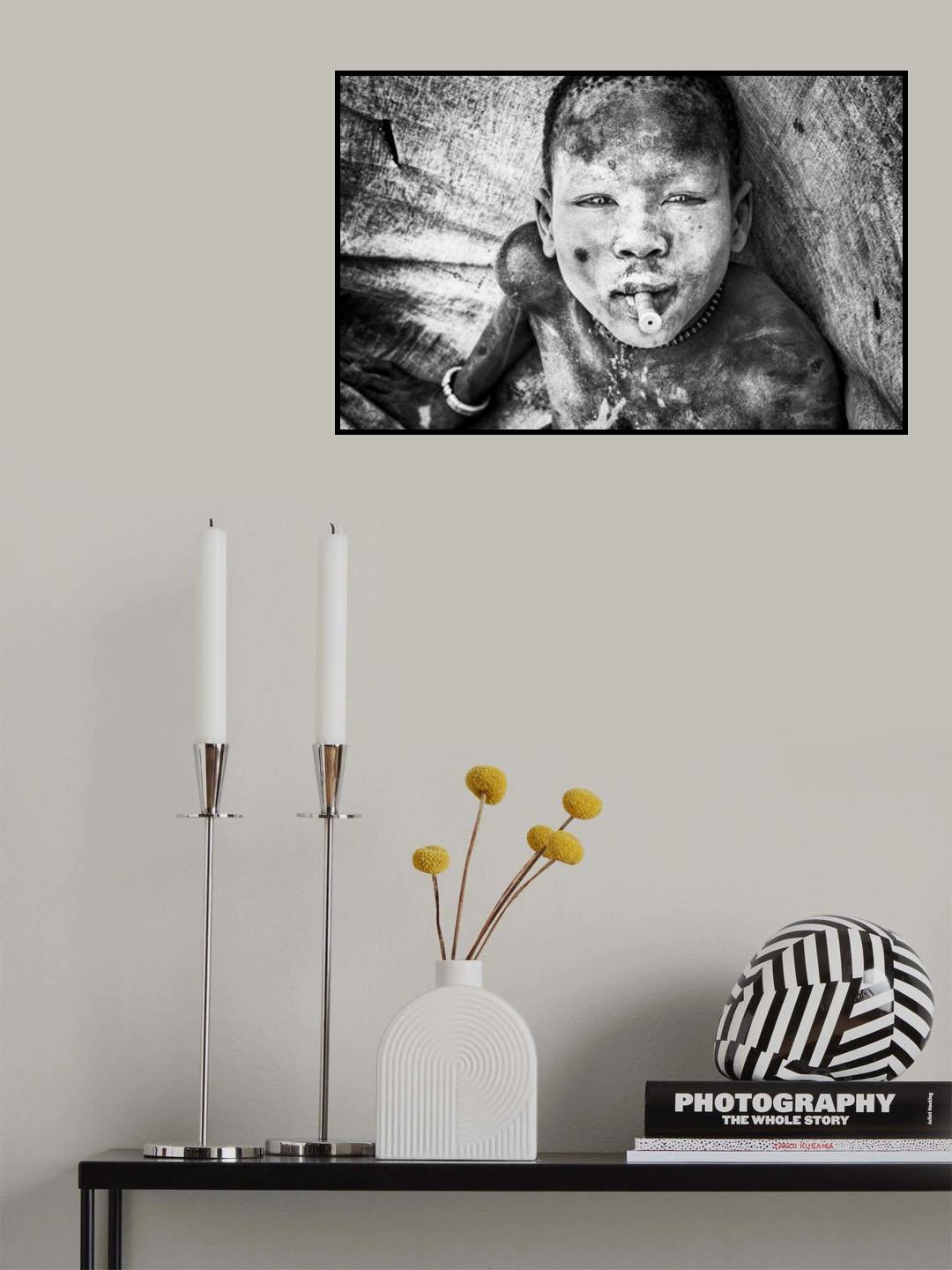 Mundari child playing with a bullet casing - South Sudan Poster och Canvastavla