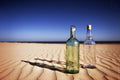 Bottles on sand Poster och Canvastavla