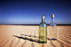 Bottles on sand Poster och Canvastavla