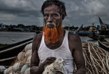 A man from Bangladesh untangling nets. Poster och Canvastavla