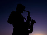 a musician playing the saxophone at sunset Poster och Canvastavla