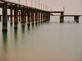 old pier on the beach and long exposure sea waves Poster och Canvastavla