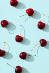 Cherries on turquoise background Poster och Canvastavla
