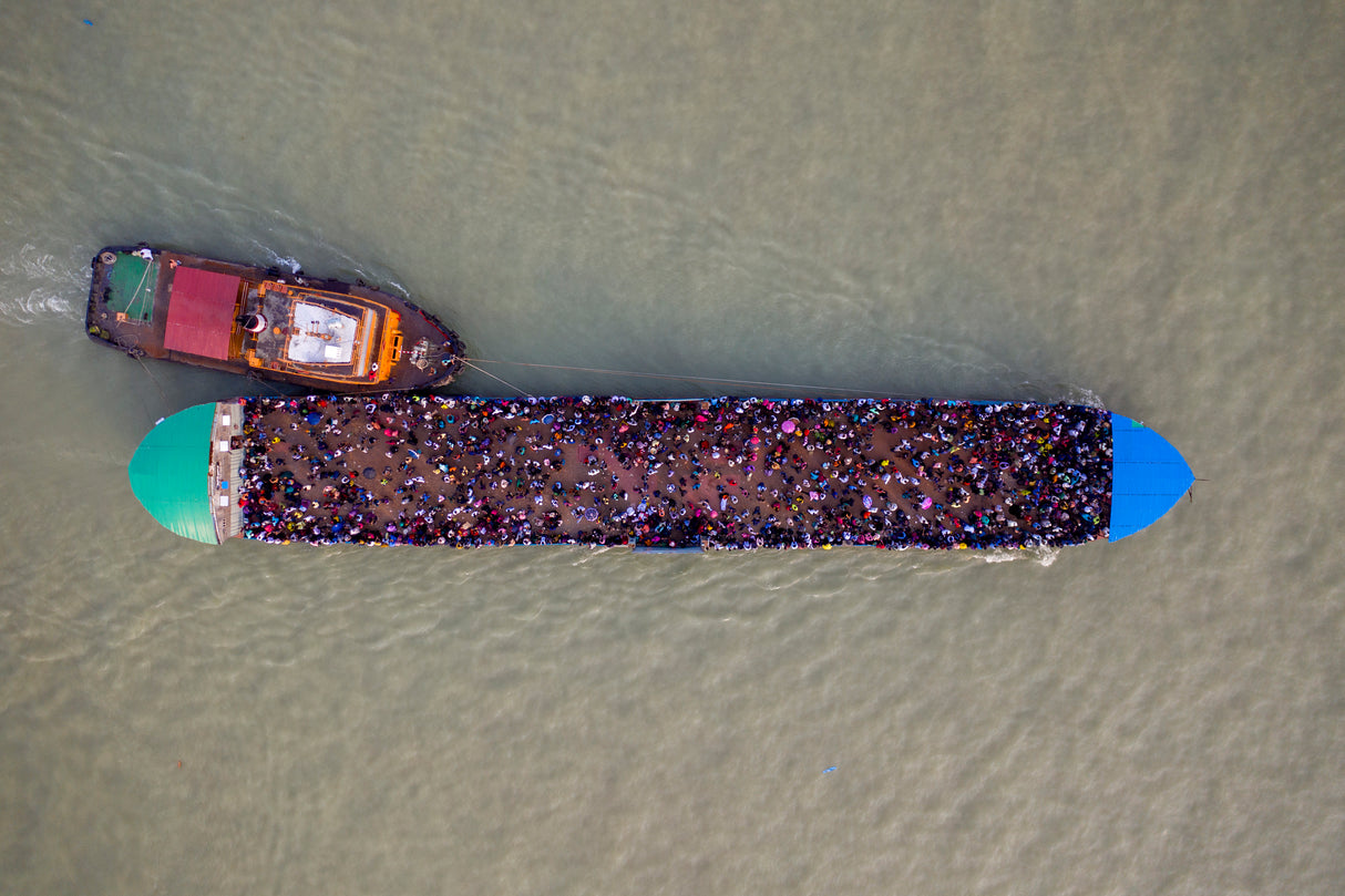 Migrant people are seen on an overcrowded ferry to get home to celebrate Eid al-Fitr Poster och Canvastavla