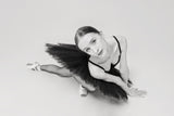 portrait of a ballerina in a black tutu lying on the floor leaning on her hands top view Poster och Canvastavla