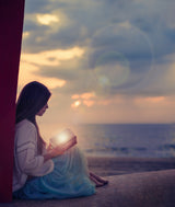 Woman sitting on a beach with illuminated book Poster och Canvastavla
