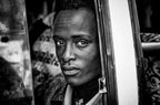 Ethipian man looking throught the bus´ window Poster och Canvastavla