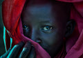 Ethiopian child covered in a red robe. Poster och Canvastavla