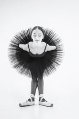 peacock. a ballerina in a black tutu is leaning forward with her arms crossed behind her back Poster och Canvastavla