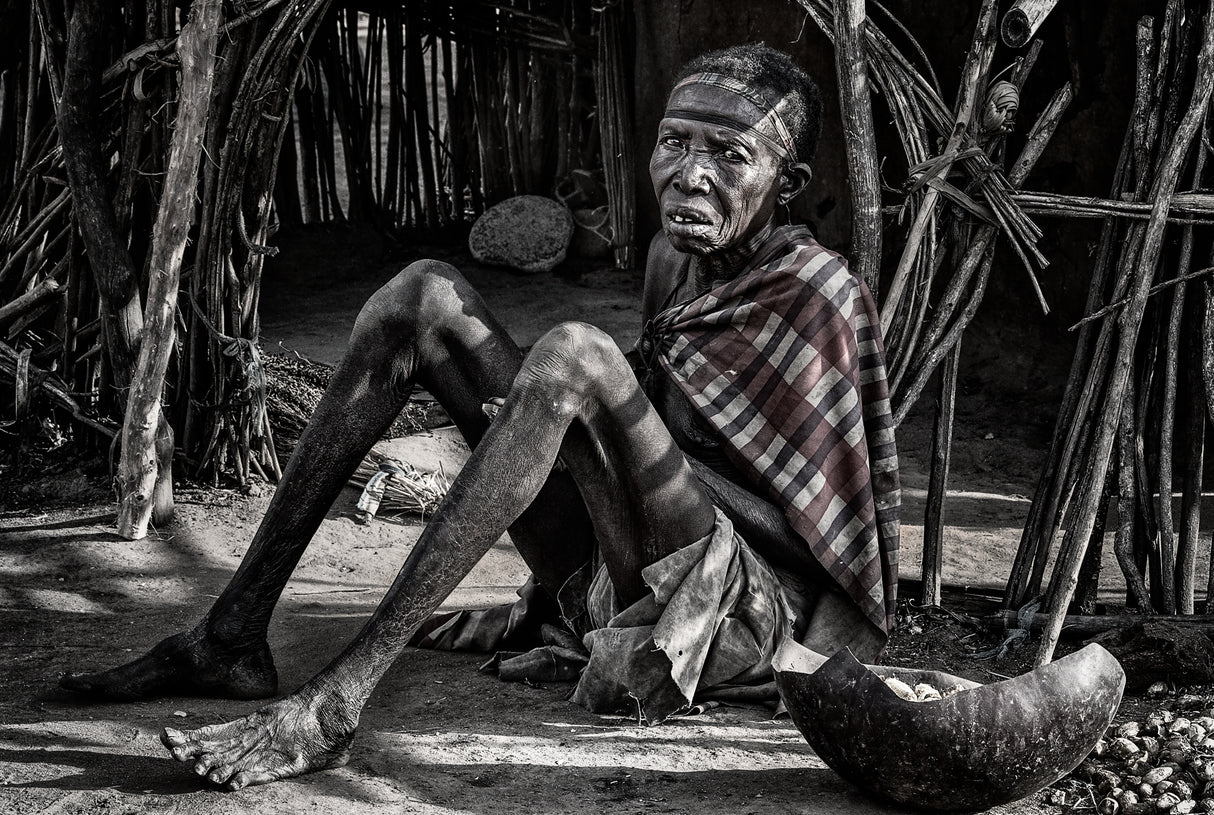 Elderly woman at the entrance of her home in a Laarim tribe village. Poster och Canvastavla