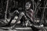 Elderly woman at the entrance of her home in a Laarim tribe village. Poster och Canvastavla