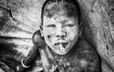 Mundari child playing with a bullet casing - South Sudan Poster och Canvastavla