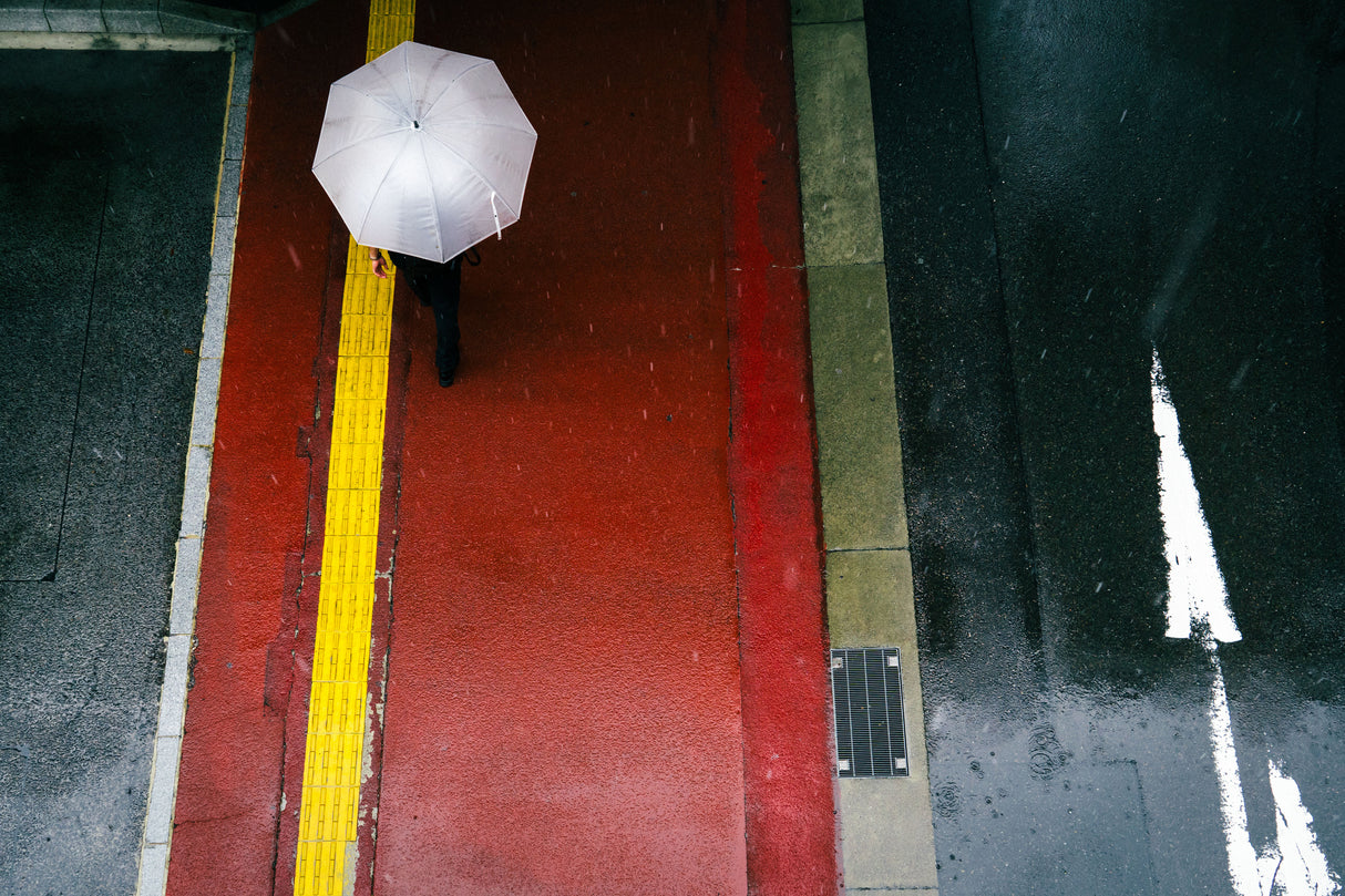 The red sidewalk and a white umbrella Poster och Canvastavla