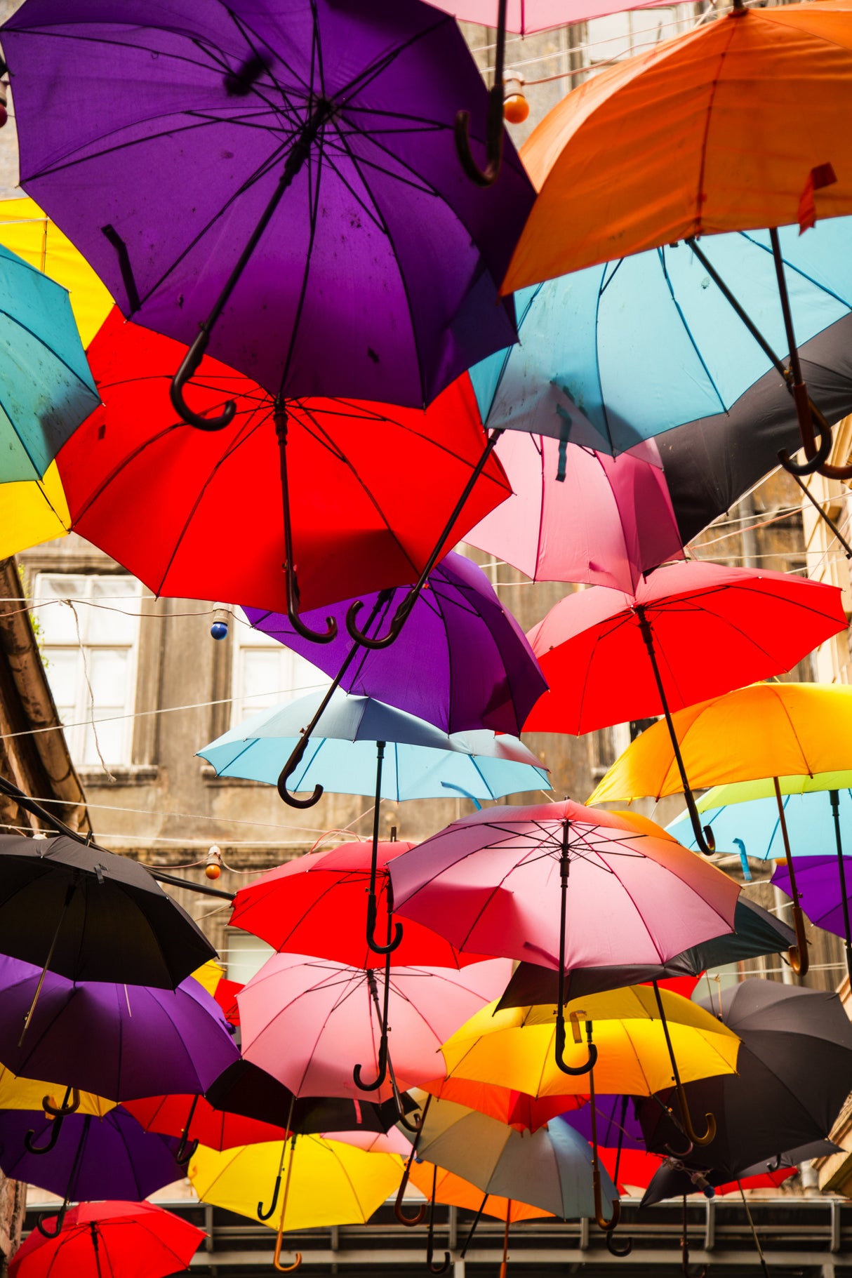 old building and decorative umbrellas Poster och Canvastavla