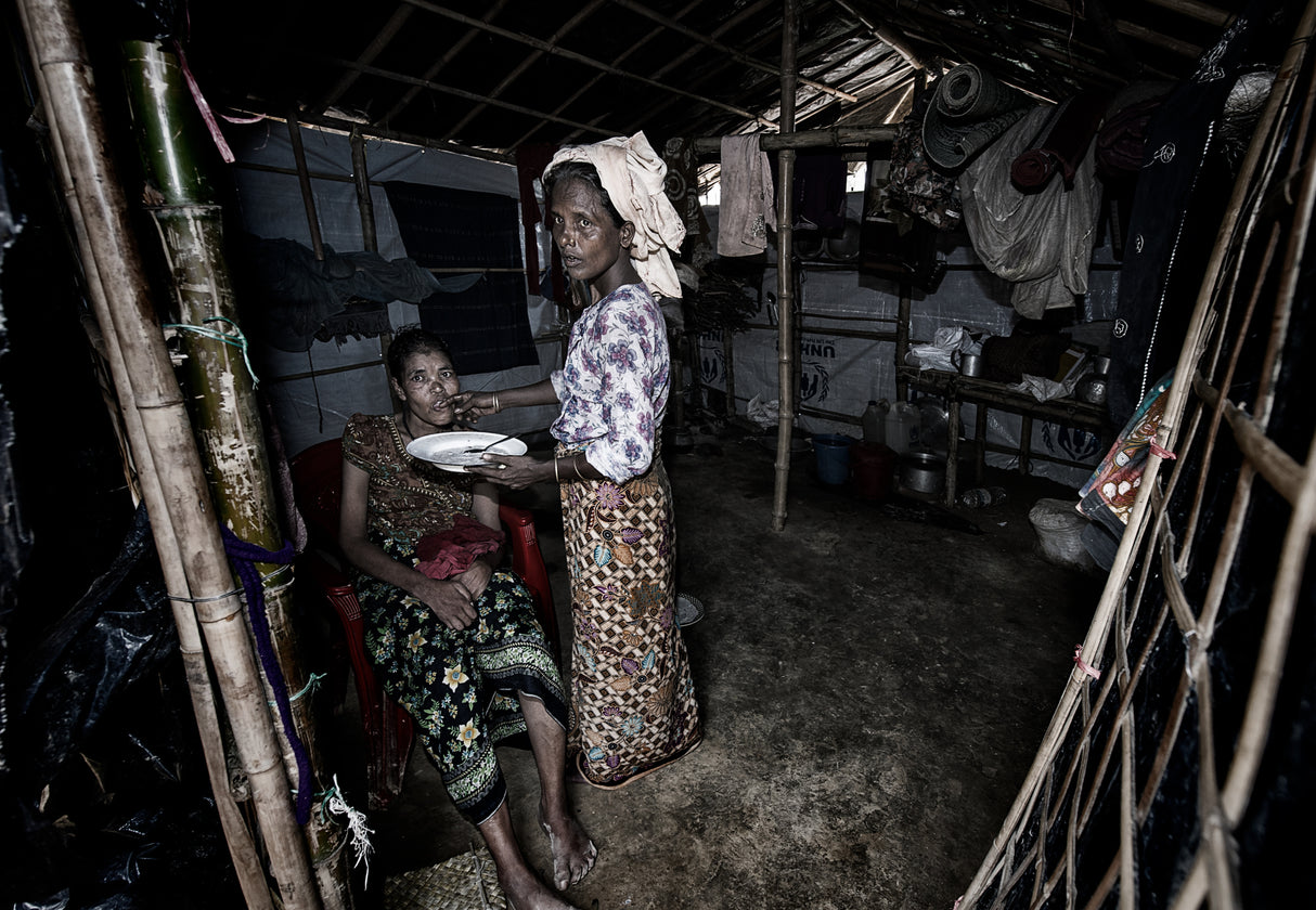 Feeding a disabled woman - Rohingya refugee people. Poster och Canvastavla