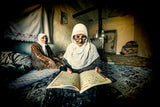 The old woman is reading the Koran. Poster och Canvastavla