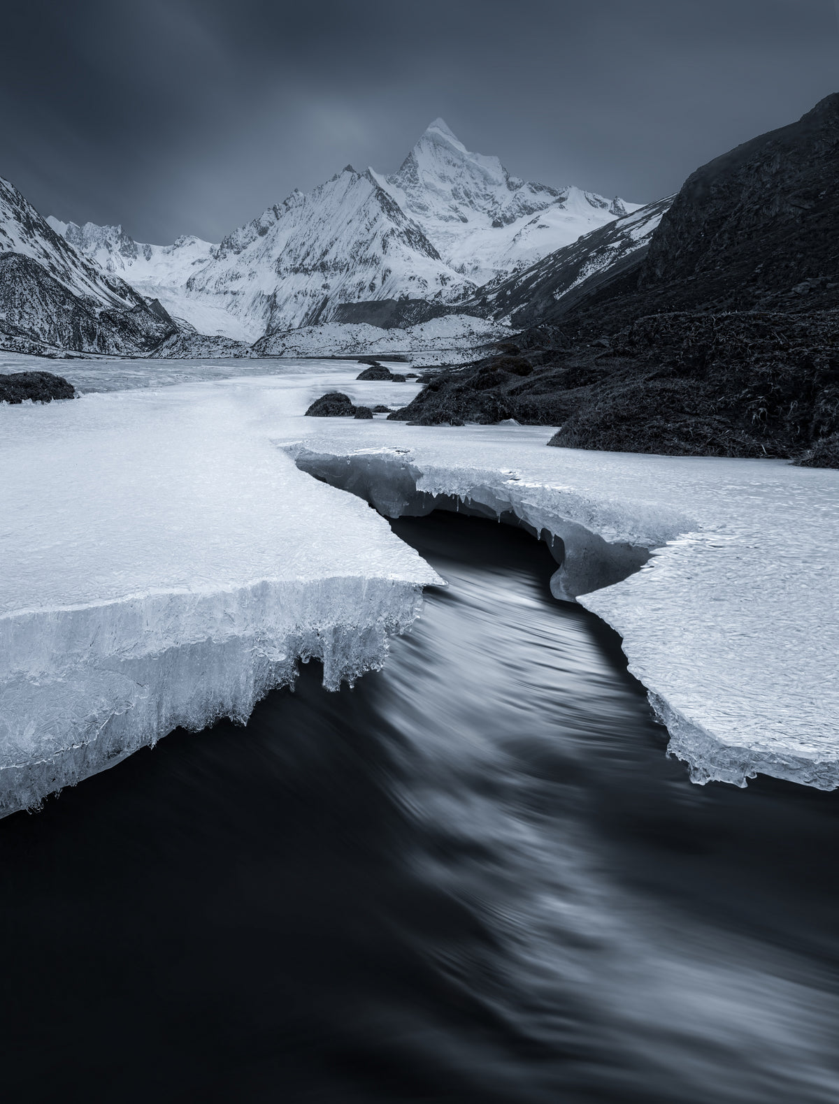 A stream under a snowy mountain Poster och Canvastavla