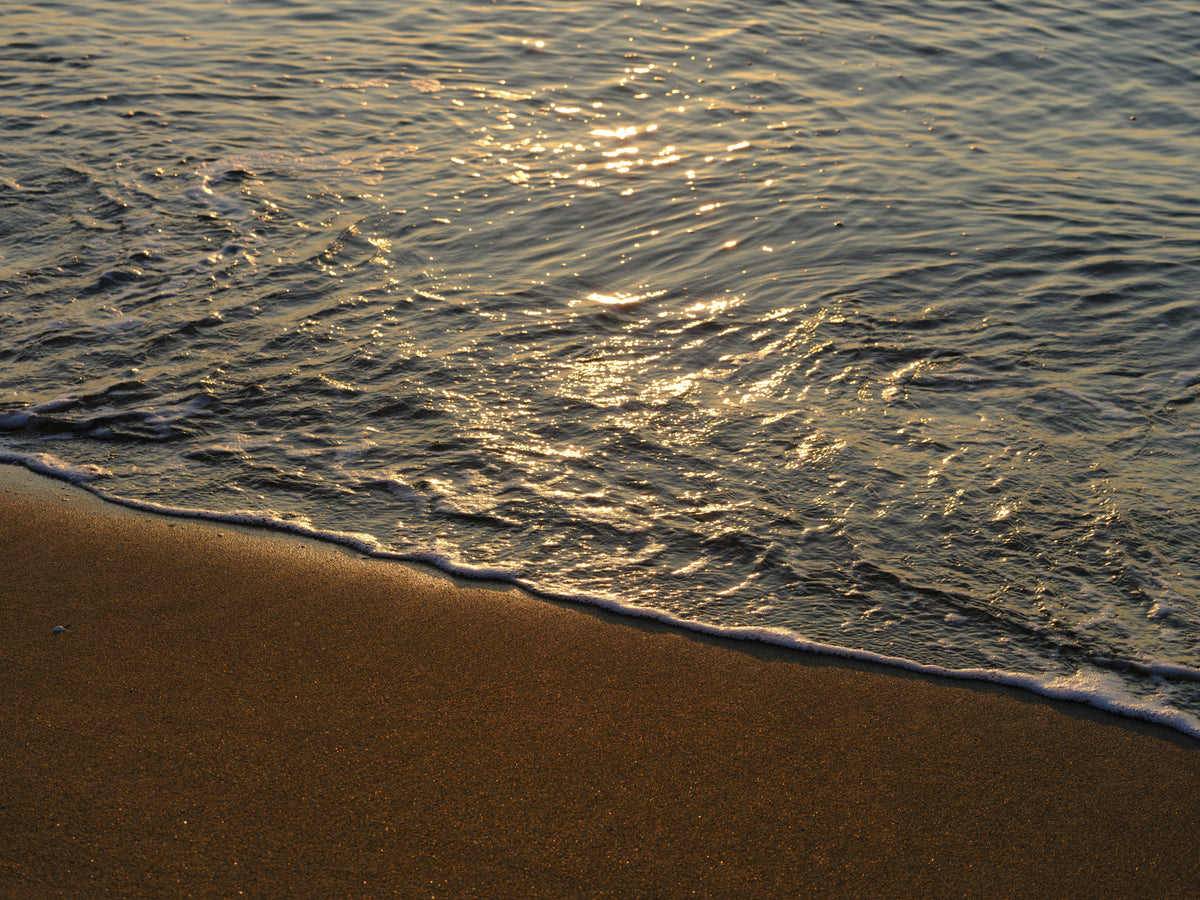 sea waves on the beach at sunset Poster och Canvastavla