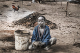Mundari child collecting dung - South Sudan Poster och Canvastavla