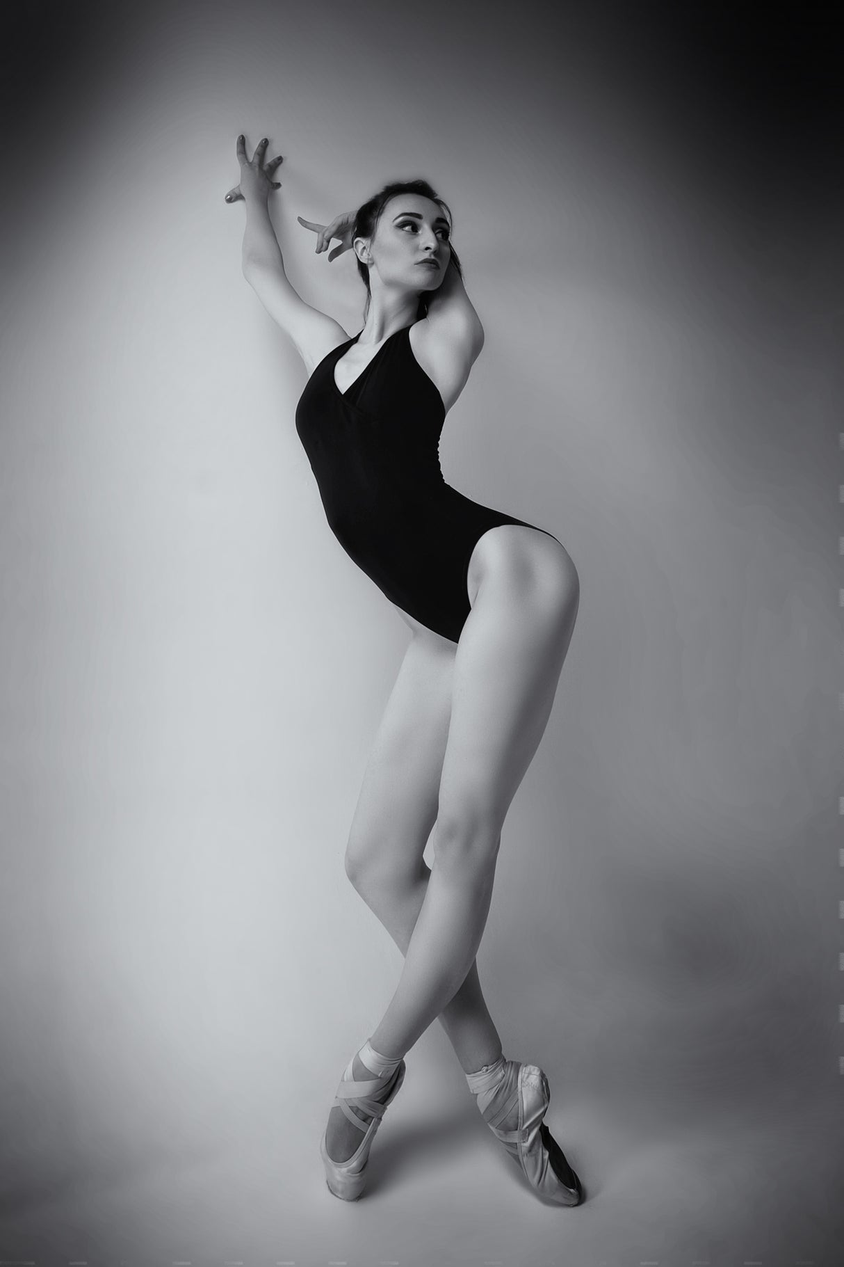 ballerina in a bodysuit improvises classical and modern choreography in a photo studio Poster och Canvastavla