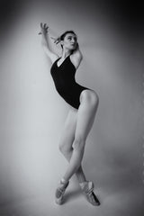 ballerina in a bodysuit improvises classical and modern choreography in a photo studio Poster och Canvastavla