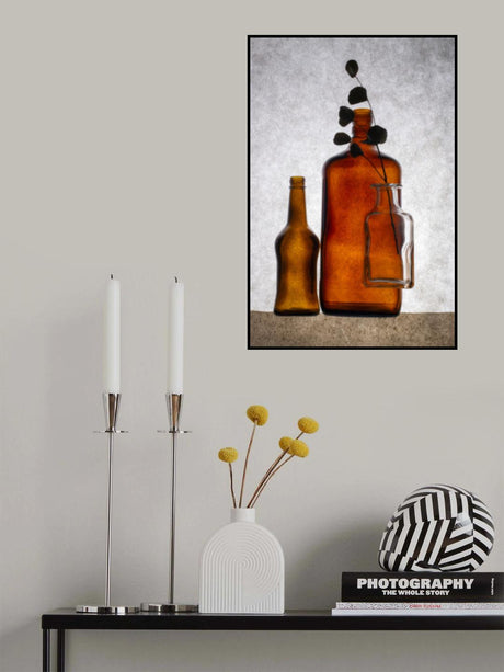 Still life with colored bottles and a dried twig Poster och Canvastavla