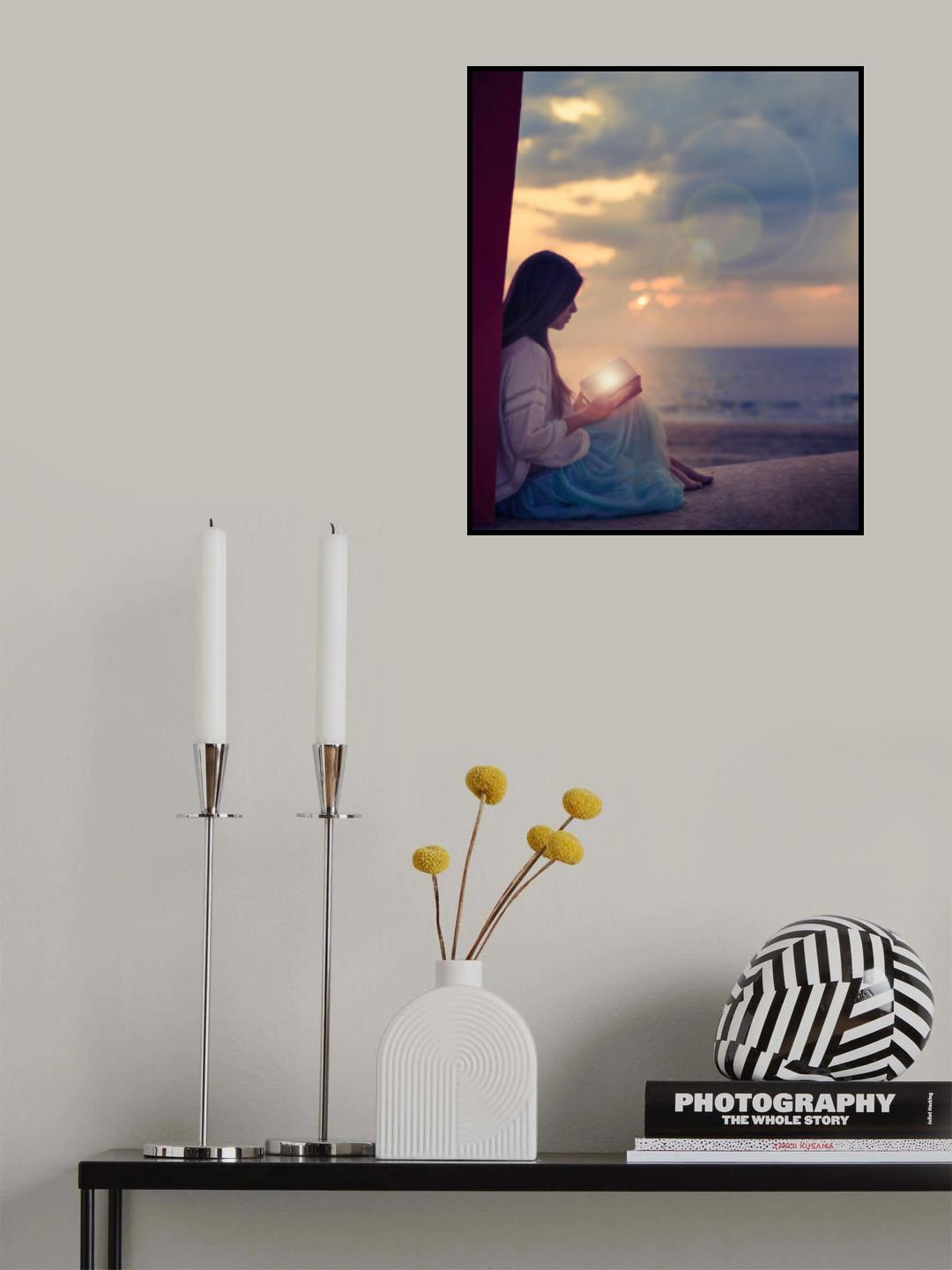 Woman sitting on a beach with illuminated book Poster och Canvastavla