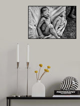 Mundari child playing with a bullet casing - South Sudan Poster och Canvastavla
