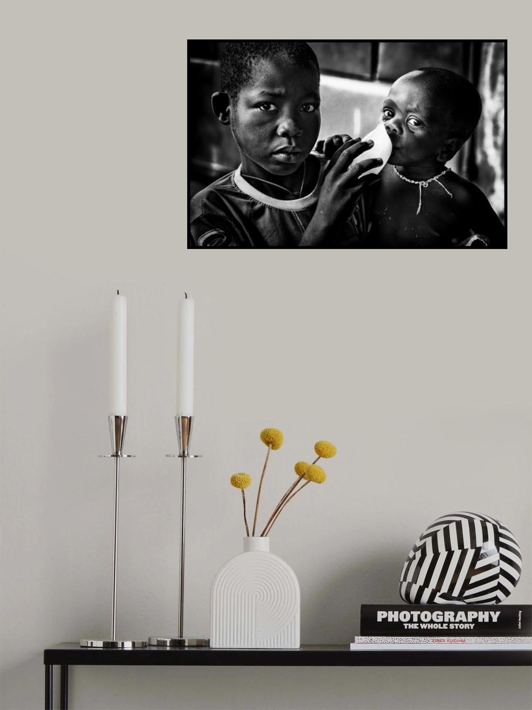 Quenching his brother´s thirst with a frozen water bag - Benin Poster och Canvastavla