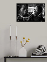 Quenching his brother´s thirst with a frozen water bag - Benin Poster och Canvastavla