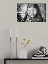 Mundari child playing with a bullet casing - South Sudan Poster och Canvastavla