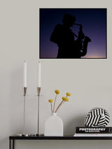 a musician playing the saxophone at sunset Poster och Canvastavla